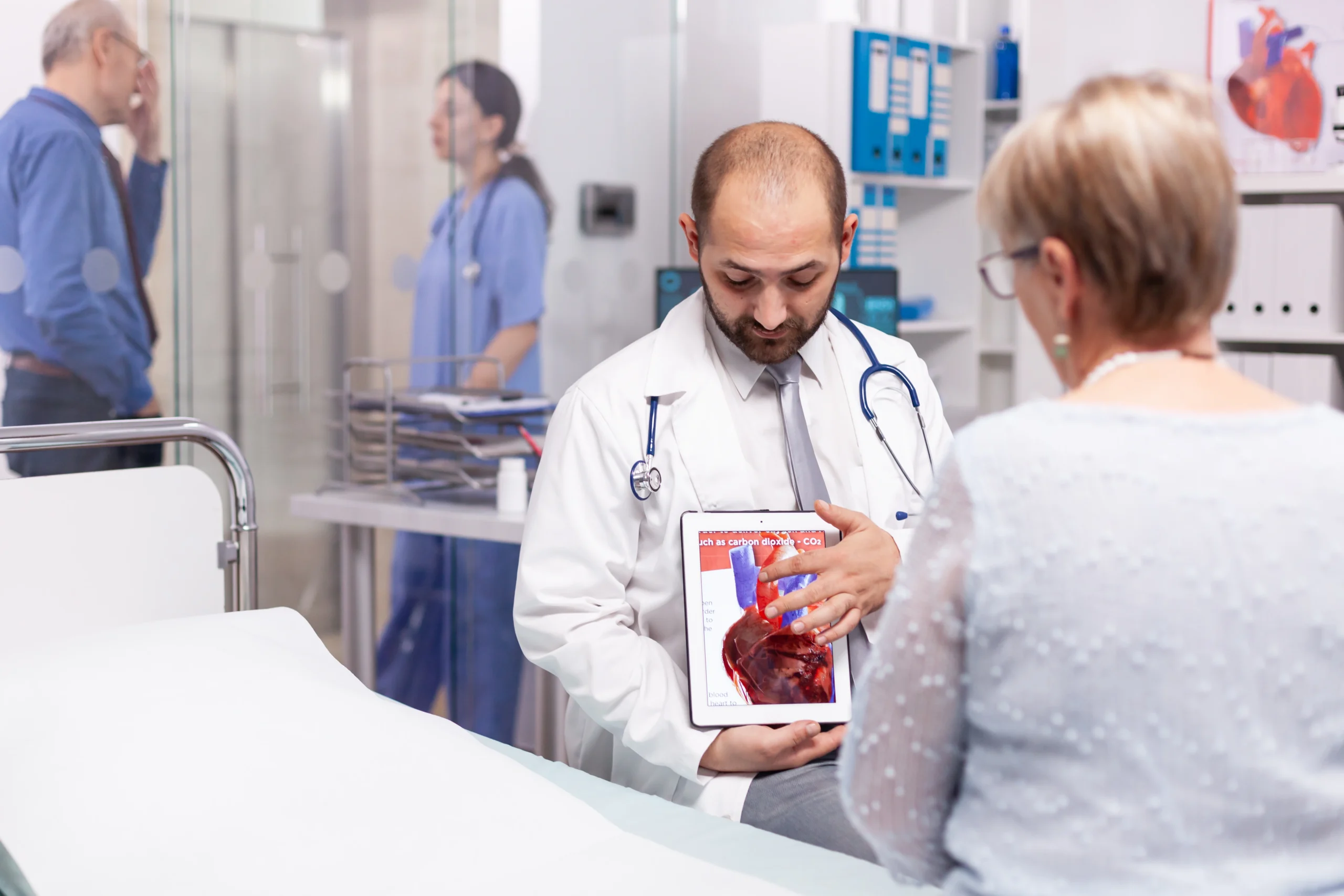 Doctor consulting a patient using a liver diagram, representing specialists in liver diseases such as hepatitis, cirrhosis, and liver cancer.