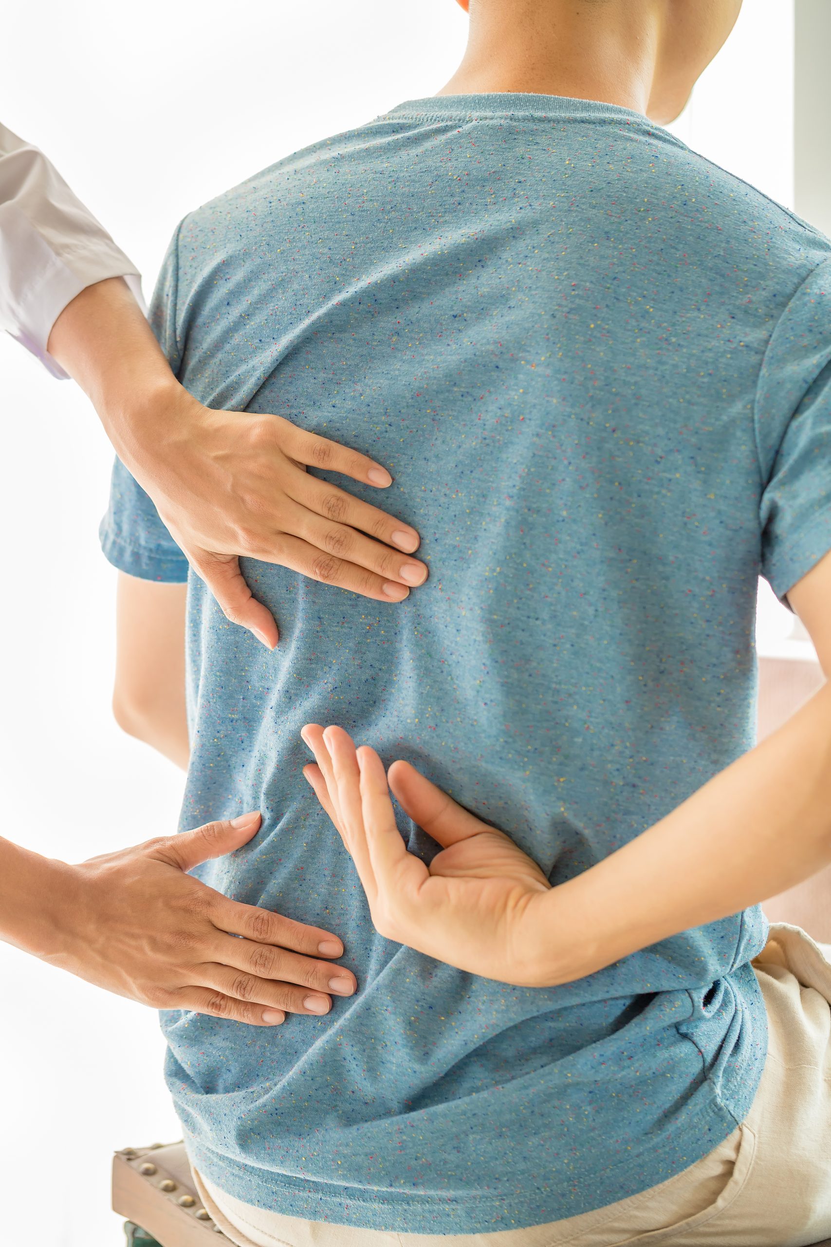 Doctor examining patient’s spine for back pain treatment at Ashtavinayak Multispeciality Hospital Panvel