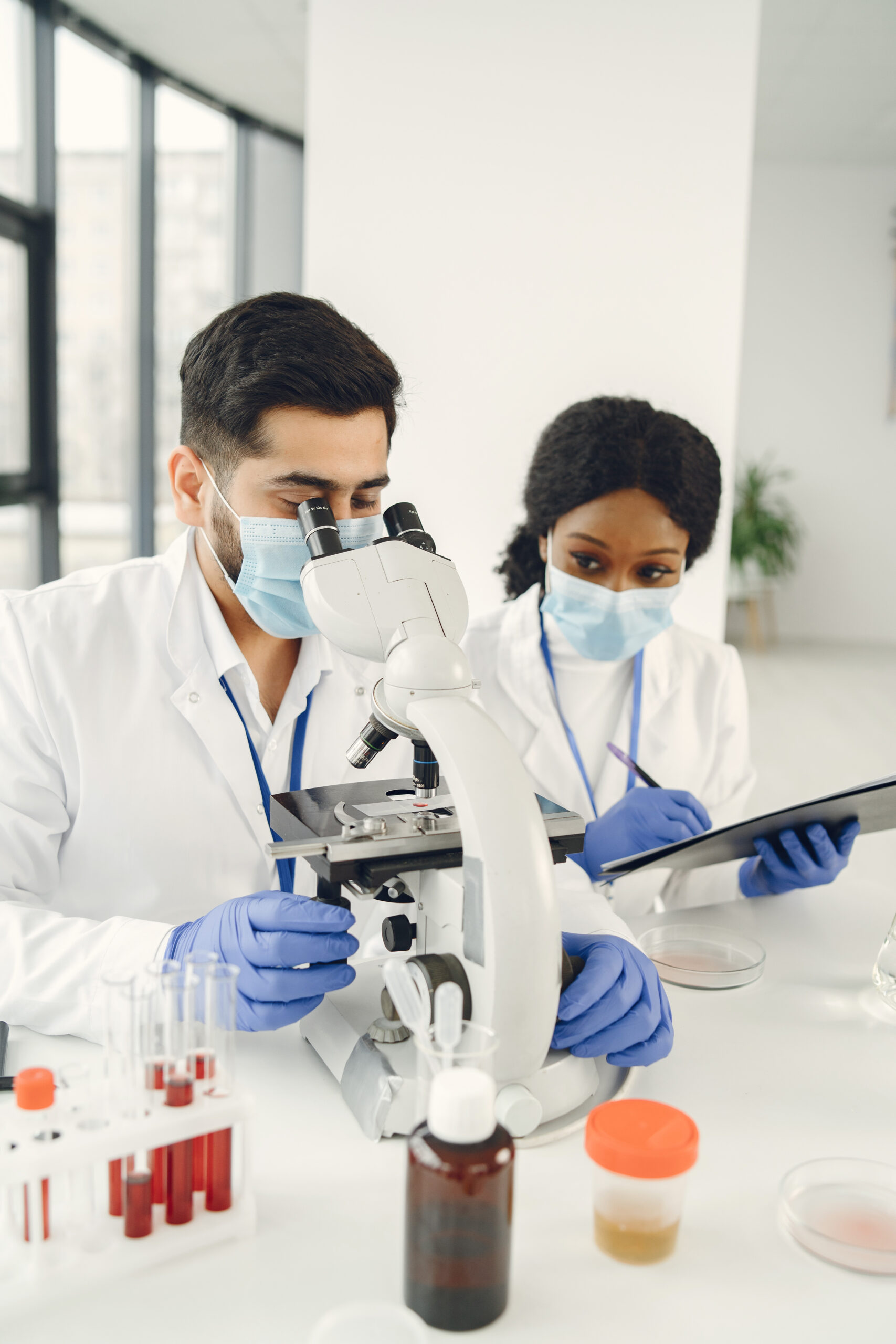 Doctors analyzing samples under a microscope – Advanced diagnostic imaging at Ashtavinayak Hospital Panvel