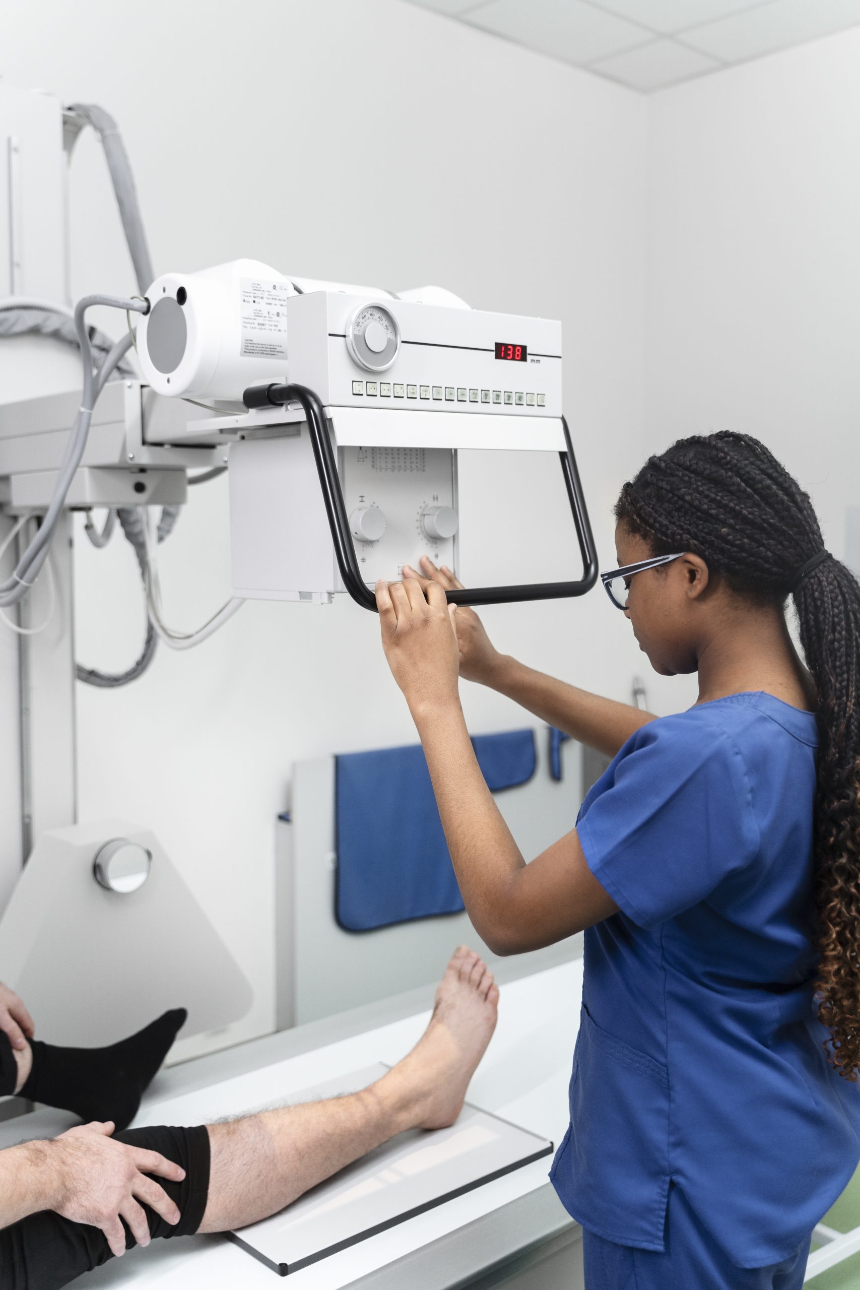 Technician positioning patient's leg for imaging – Arthroscopy diagnosis and care at Ashtavinayak Hospital Panvel