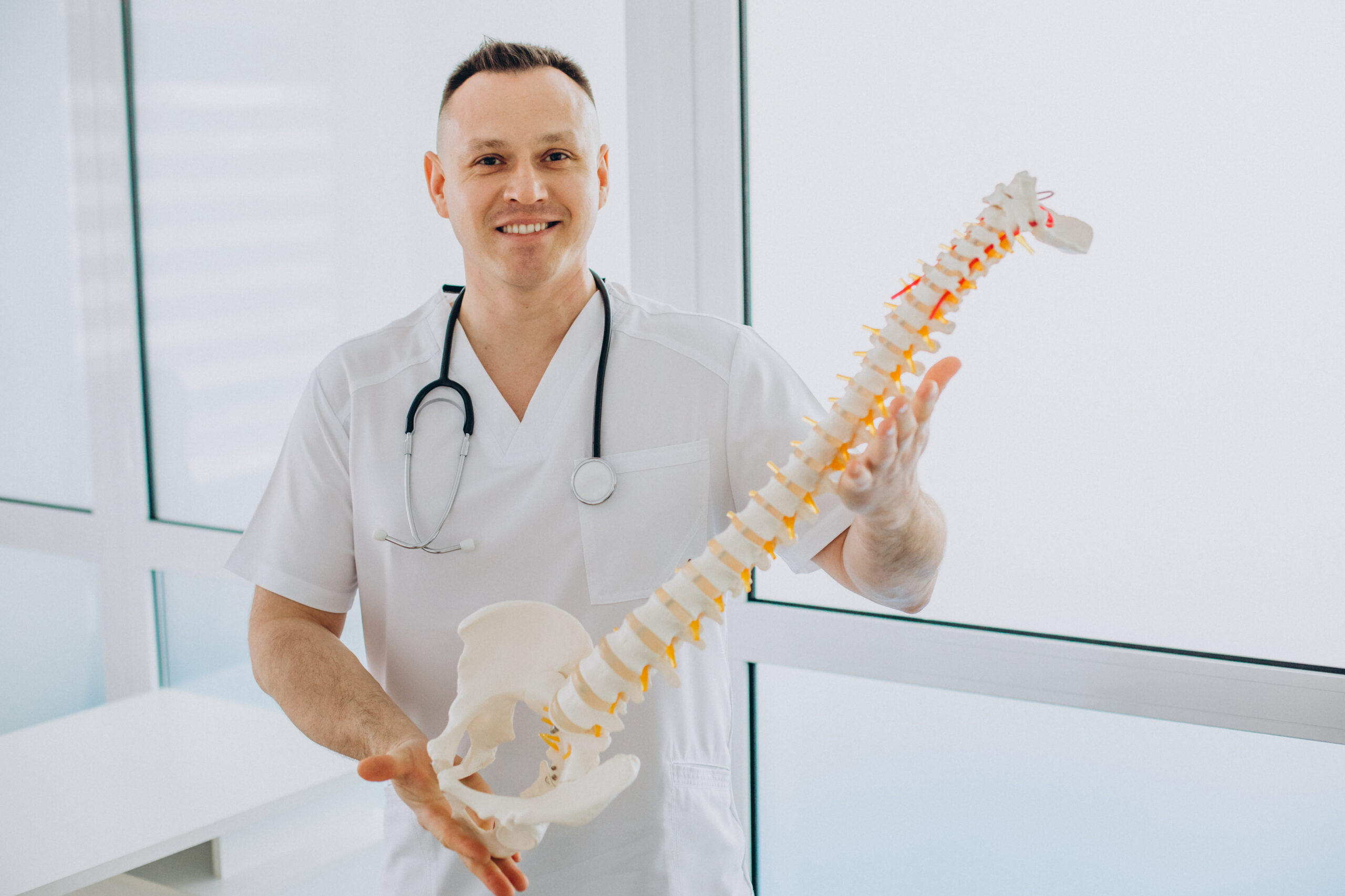 Orthopedic doctor holding a spine model – Tips to prevent bone and joint issues at Ashtavinayak Hospital Panvel
